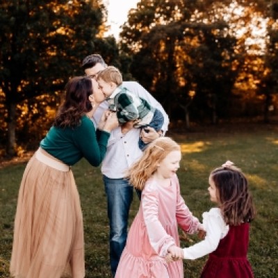 Family of five with trees in background