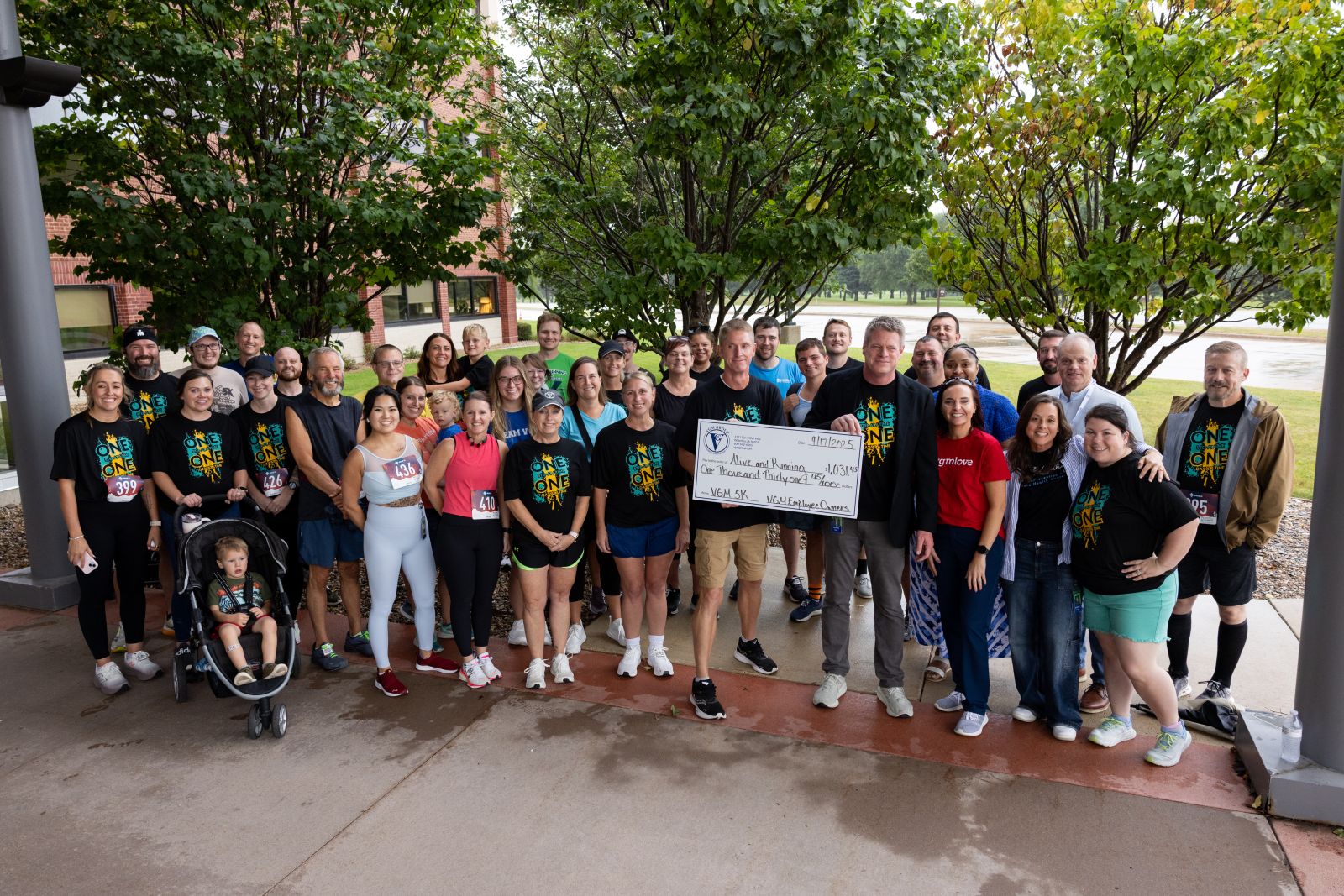 VGM employee owners holding a large check