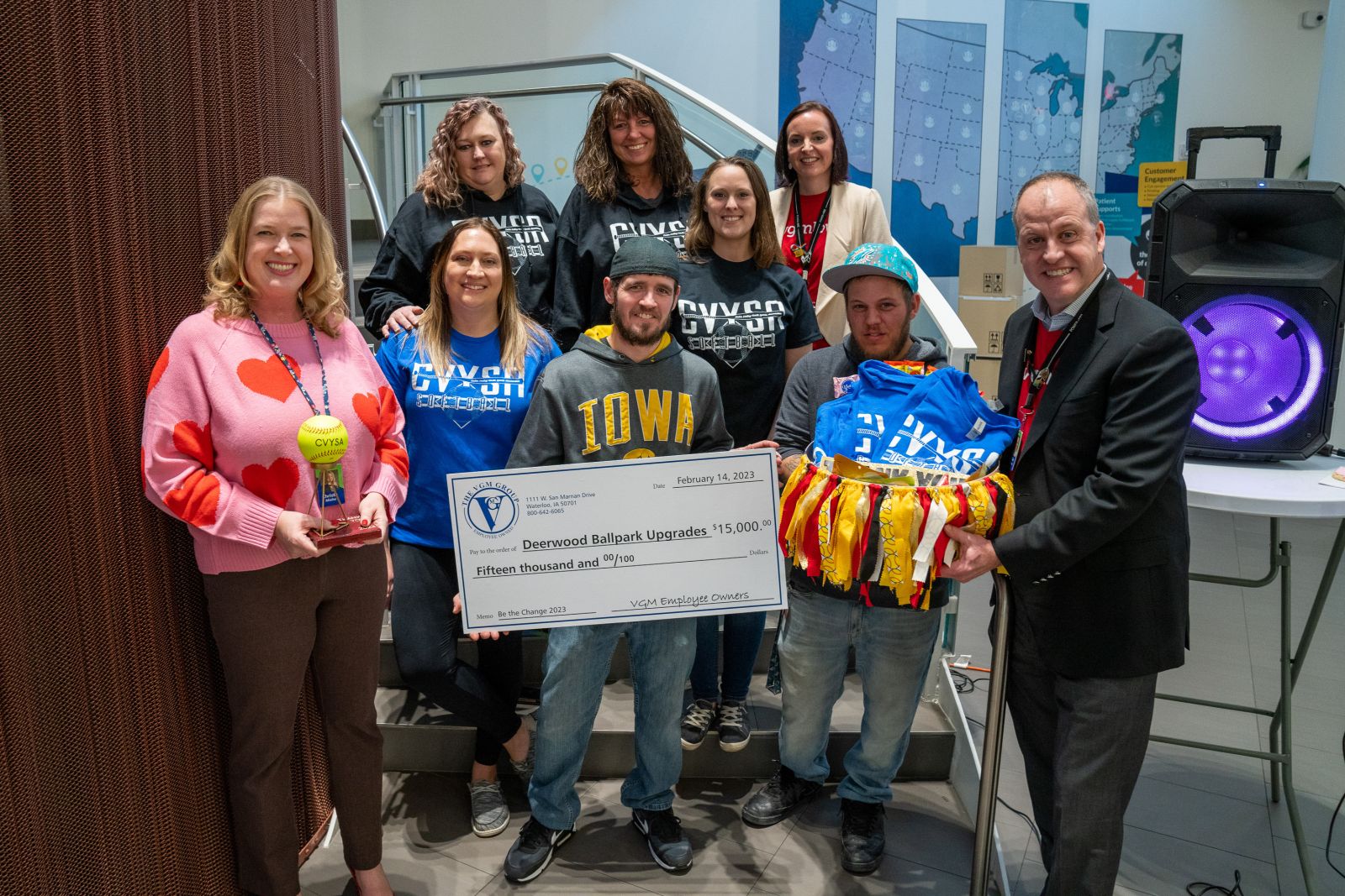 VGM employee owners holding a large check