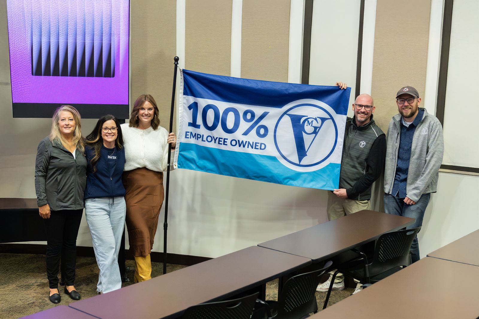 image of employee owner outside VGM smiling with other employee owners